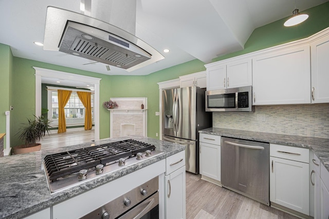 kitchen featuring white cabinets, stainless steel appliances, light hardwood / wood-style flooring, and tasteful backsplash