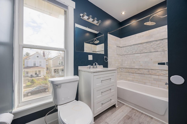 bathroom with a wealth of natural light, vanity, wood-type flooring, and toilet