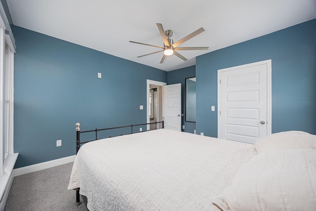 bedroom with a closet, dark carpet, and ceiling fan