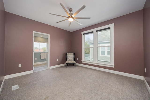 unfurnished room featuring ceiling fan, carpet floors, and a healthy amount of sunlight