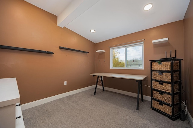 carpeted office featuring lofted ceiling with beams