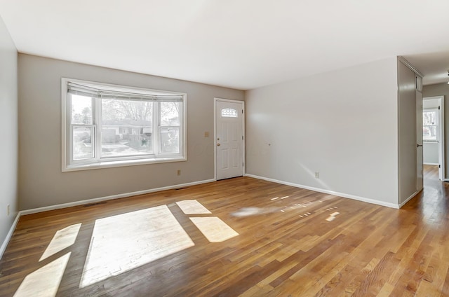 foyer entrance featuring hardwood / wood-style floors and plenty of natural light