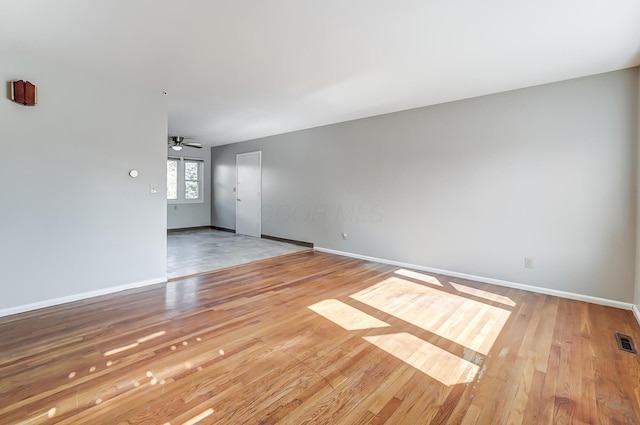 unfurnished room with ceiling fan and hardwood / wood-style floors