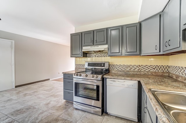 kitchen with gray cabinetry, dishwasher, backsplash, sink, and stainless steel range