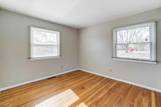 unfurnished room featuring hardwood / wood-style flooring