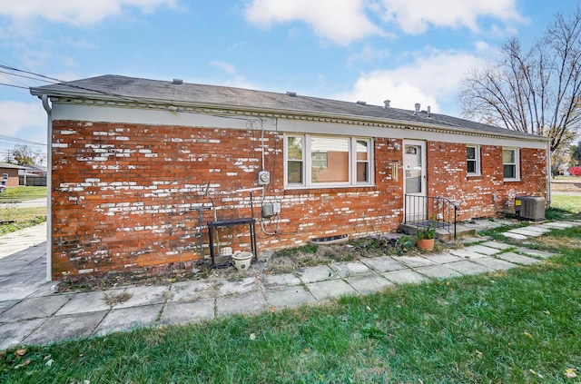 back of house featuring central AC unit