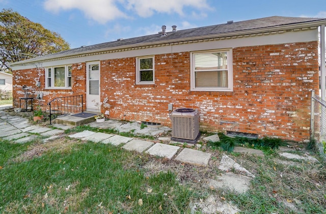 rear view of property with central AC unit