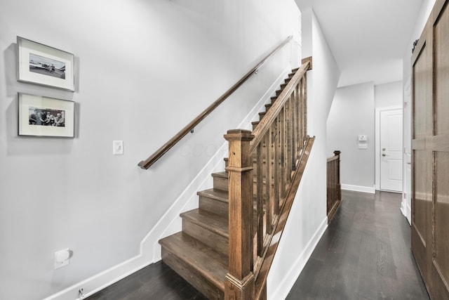 stairs featuring hardwood / wood-style flooring and a barn door