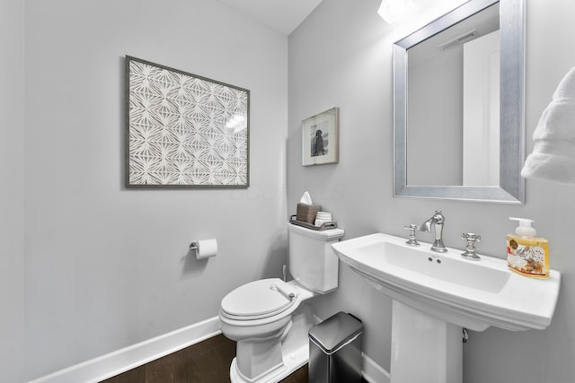 bathroom with sink, toilet, and hardwood / wood-style flooring