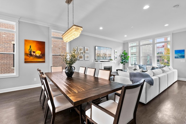 dining area featuring a notable chandelier, crown molding, and dark wood-type flooring