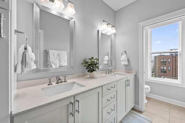 bathroom with tile patterned floors, vanity, and toilet