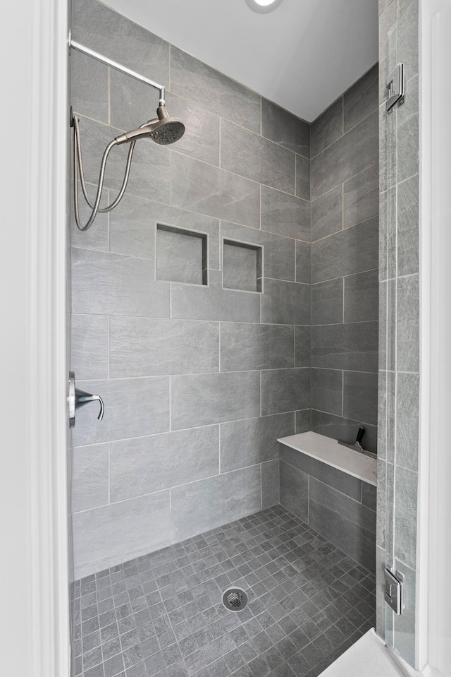 bathroom with tiled shower