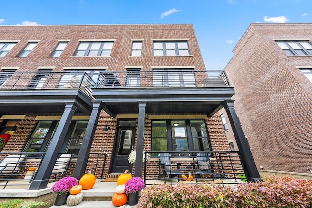 rear view of property featuring a balcony