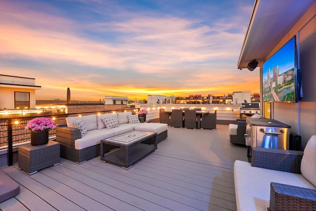 deck at dusk featuring an outdoor living space