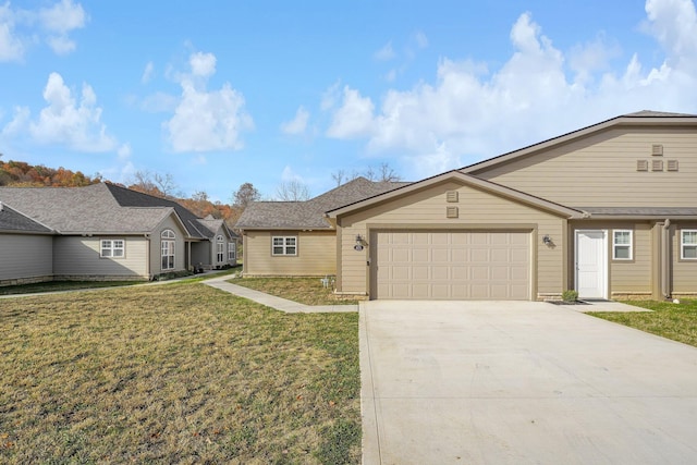 single story home featuring a front lawn and a garage