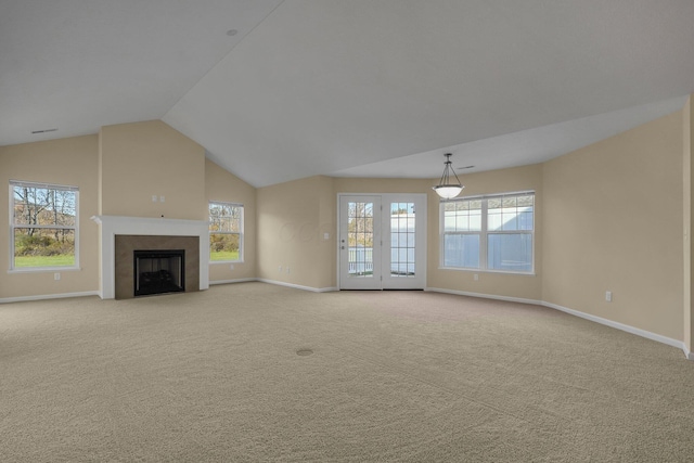 unfurnished living room featuring light carpet and vaulted ceiling