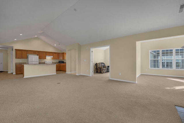 unfurnished living room featuring light carpet and vaulted ceiling