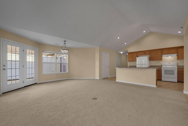 interior space featuring light carpet and vaulted ceiling