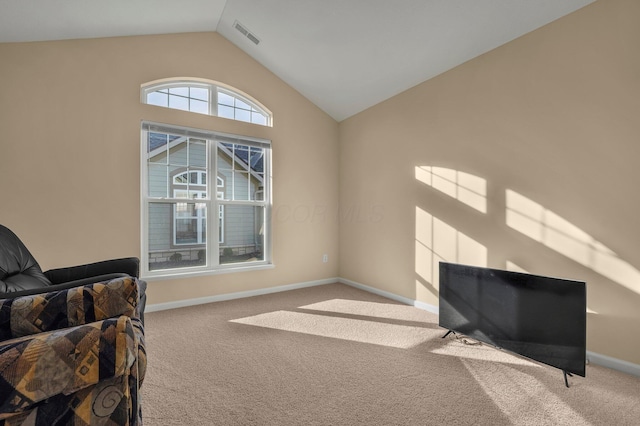 living area featuring light carpet and vaulted ceiling