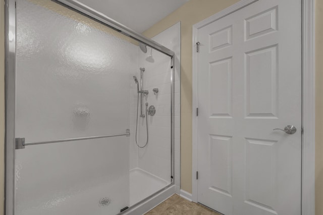 bathroom featuring a shower with door