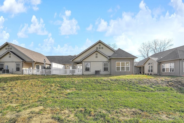 view of front of home featuring a front lawn and central AC unit