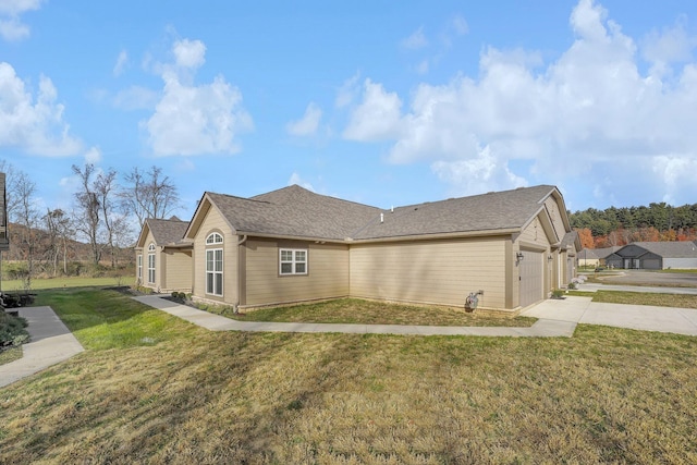 view of home's exterior featuring a yard and a garage