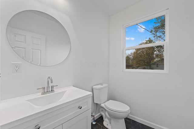 bathroom featuring tile patterned flooring, vanity, and toilet