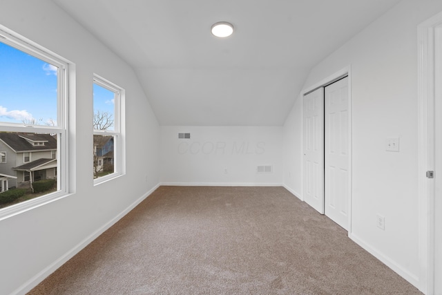 additional living space with lofted ceiling and carpet floors