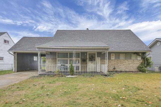 view of front of home with a carport, a porch, and a front lawn