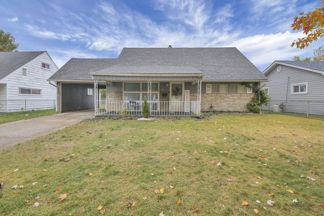 view of front of house with a carport, a porch, and a front lawn