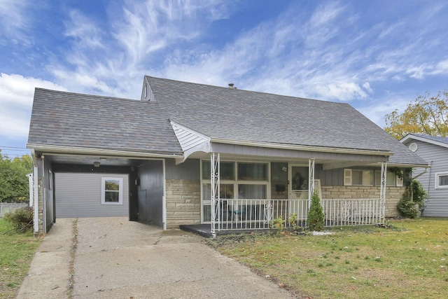 view of front of home featuring a porch, a garage, and a front lawn