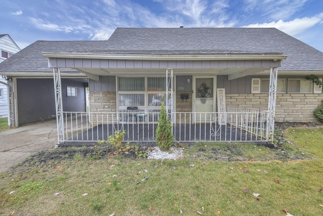 bungalow with covered porch and a front yard