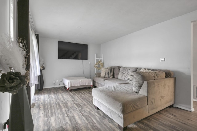 living room with a healthy amount of sunlight and dark hardwood / wood-style floors