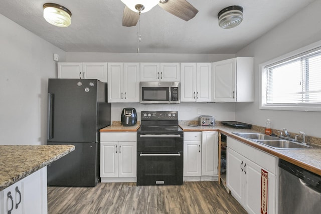 kitchen with dark hardwood / wood-style flooring, ceiling fan, sink, black appliances, and white cabinetry