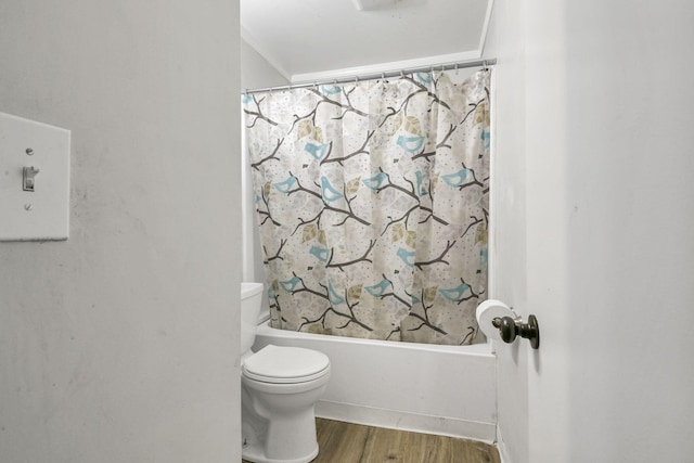 bathroom featuring toilet, wood-type flooring, and shower / tub combo