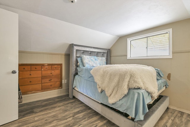 bedroom featuring dark hardwood / wood-style floors and lofted ceiling