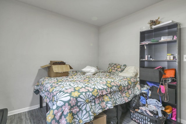 bedroom with dark hardwood / wood-style floors