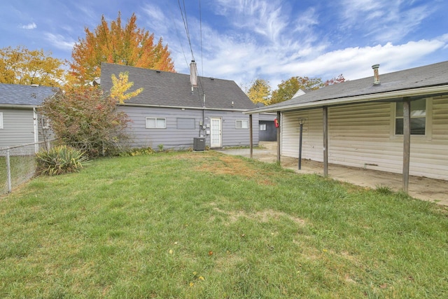 rear view of property with a lawn