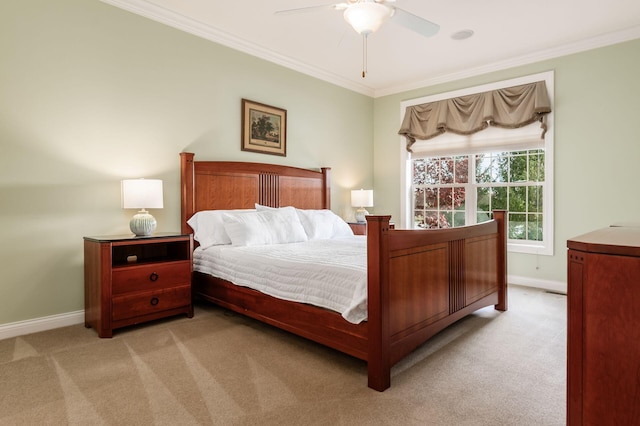 carpeted bedroom with ceiling fan and ornamental molding