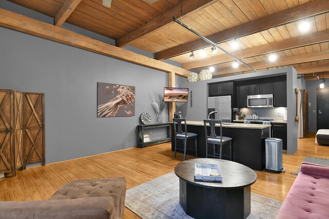 living room featuring beam ceiling, wood ceiling, light hardwood / wood-style floors, and rail lighting