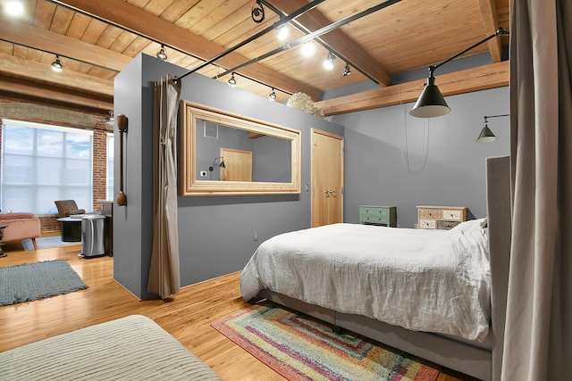 bedroom with beam ceiling, wooden ceiling, wood-type flooring, and track lighting