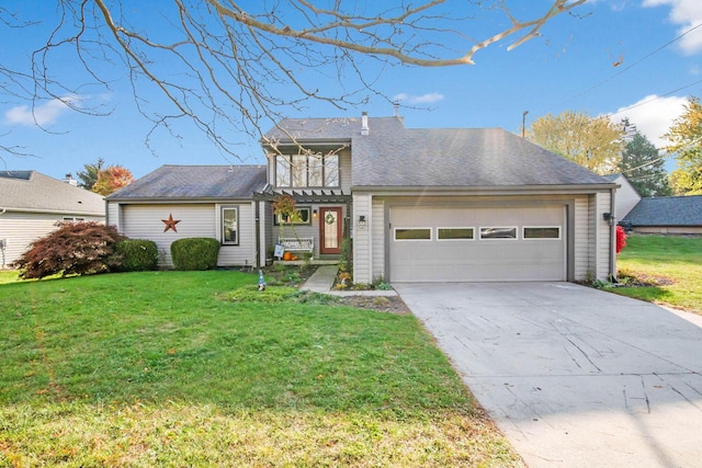 view of front of home featuring a front yard, a balcony, and a garage