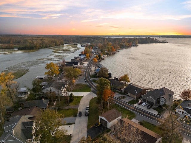 aerial view at dusk with a water view