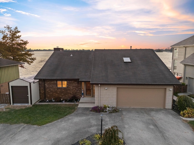 view of front of home featuring a water view and a garage