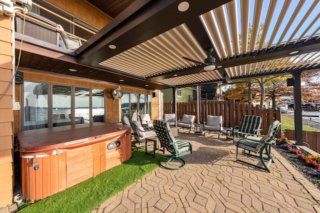 view of patio / terrace with a pergola, a hot tub, and ceiling fan