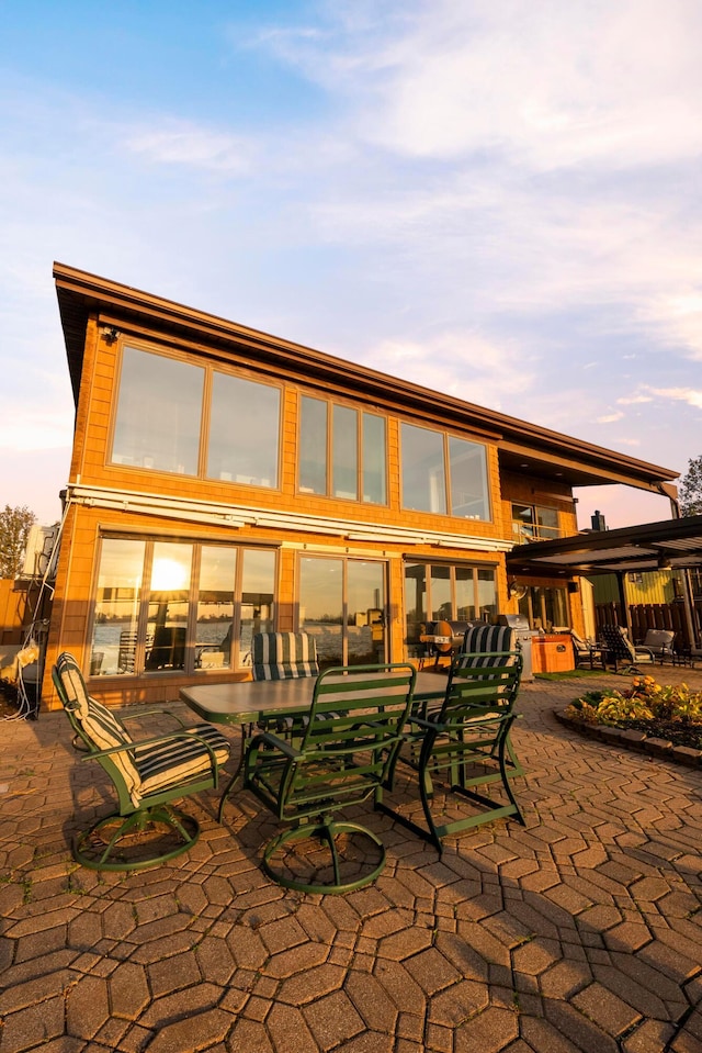 back house at dusk with a patio