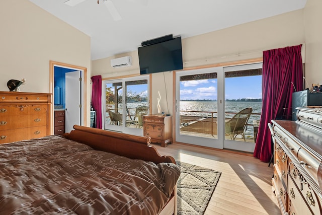 bedroom featuring ceiling fan, a wall mounted AC, lofted ceiling, access to outside, and light wood-type flooring