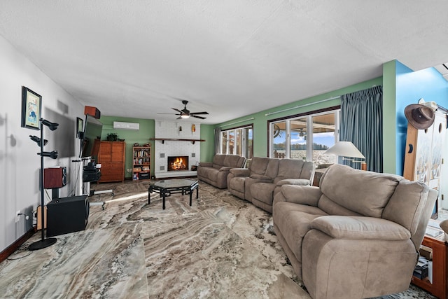 living room with a fireplace, a textured ceiling, and ceiling fan