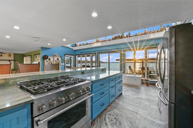 kitchen featuring a water view, blue cabinetry, and appliances with stainless steel finishes