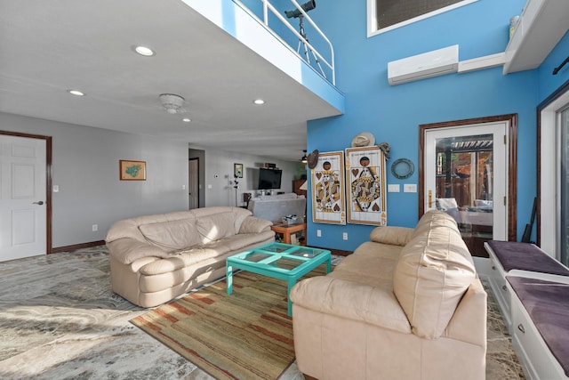 living room featuring ceiling fan and a wall mounted AC